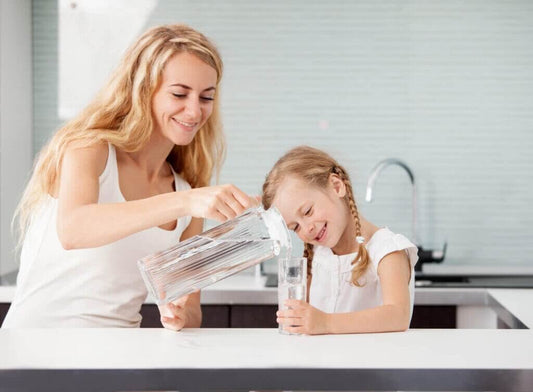 Mother pour hydrogen water to her daughter