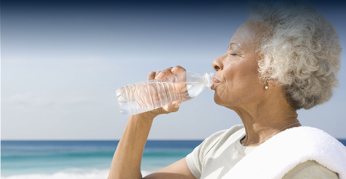 woman drinking water from a bottle