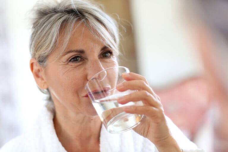 senior woman drinks hydrogen water