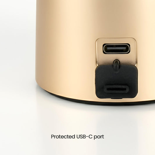 Gold electronic device with a protected USB-C port on a white background