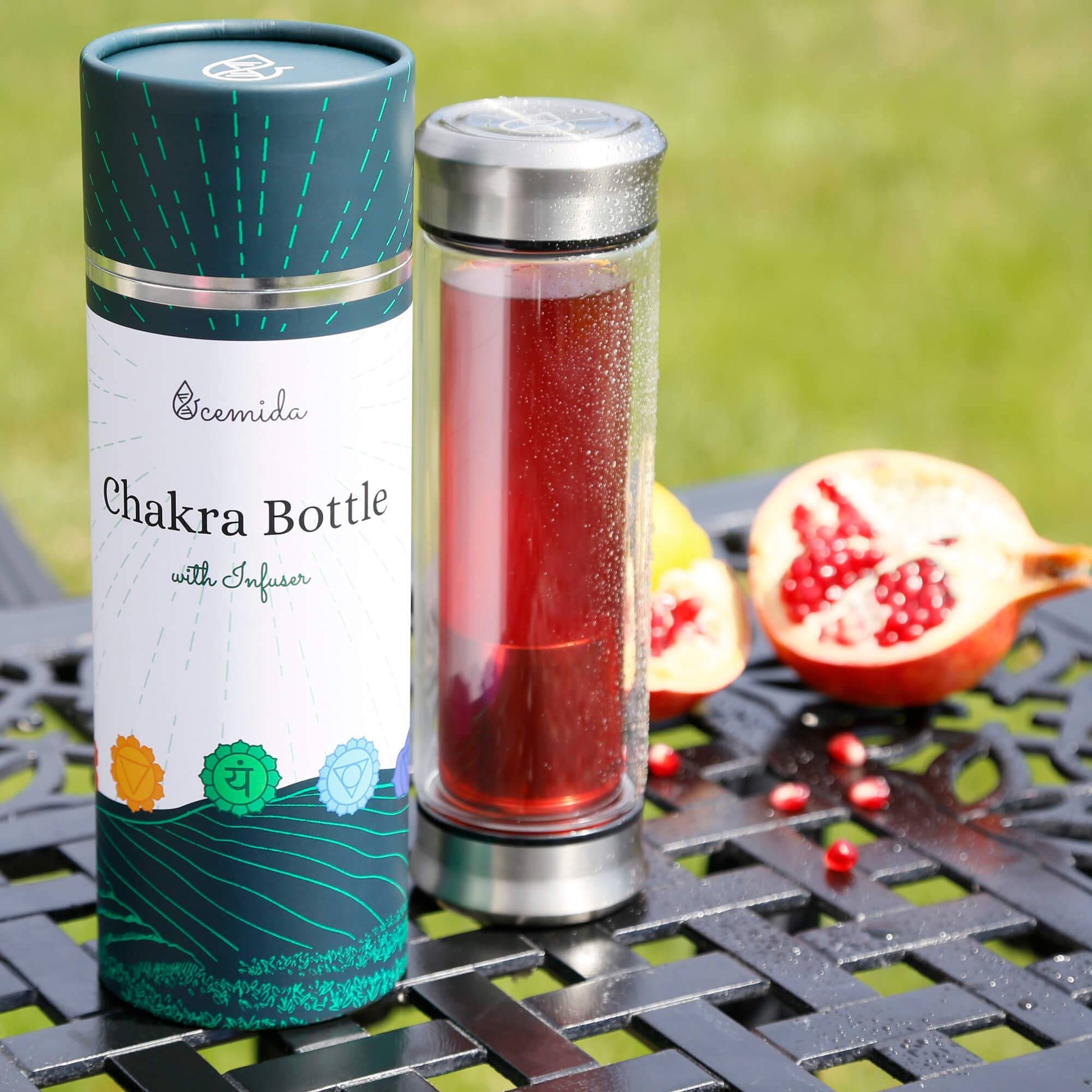 Glass tea bottle with red tea and pomegranate